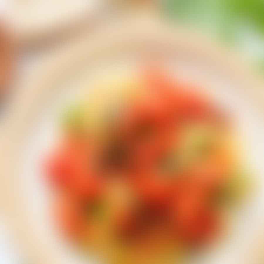 Fresh Italian ingredients including ripe tomatoes, olive oil, cheese, and pasta